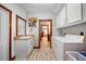 Functional laundry room with a sink, white cabinets, and laundry machines, offering convenience and organization at 740 W Virginia Ave, Punta Gorda, FL 33950