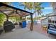 Outdoor living space offers a covered patio, grill, and colorful seating, perfect for entertaining at 740 W Virginia Ave, Punta Gorda, FL 33950