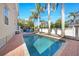 Relaxing pool with a clear blue surface and brick pavers, complemented by palm trees at 740 W Virginia Ave, Punta Gorda, FL 33950