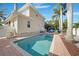 Inviting pool surrounded by lush landscaping with a charming gazebo and outdoor seating area at 740 W Virginia Ave, Punta Gorda, FL 33950