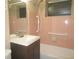 Functional bathroom with a vanity, tile shower, and safety grab bars installed at 8544 Herbison Ave, North Port, FL 34287