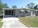 Charming single-story home with a screened carport and cozy curb appeal in a sunny setting at 8544 Herbison Ave, North Port, FL 34287