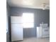 Clean kitchen featuring tile floors, a window for natural light, and white appliances at 8544 Herbison Ave, North Port, FL 34287
