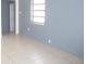 Neutral toned living room showcasing tile floors and natural light from the window at 8544 Herbison Ave, North Port, FL 34287
