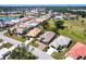 Wide aerial shot of a residential home next to a lake and golf course under clear blue skies at 10227 Windsong Rd, Punta Gorda, FL 33955
