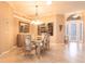 Dining room with stylish chandelier, tile floors, and access to the front door at 10227 Windsong Rd, Punta Gorda, FL 33955