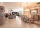 Open concept shows the dining room with chandelier alongside the spacious living room at 10227 Windsong Rd, Punta Gorda, FL 33955