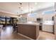 Bright kitchen featuring white cabinets, modern appliances, and a breakfast bar overlooking the dining area and lanai at 10227 Windsong Rd, Punta Gorda, FL 33955