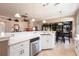 Well-lit kitchen with white cabinetry, stainless steel dishwasher, and an open layout that flows into the living area at 10227 Windsong Rd, Punta Gorda, FL 33955