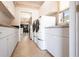 Practical laundry room featuring modern appliances, storage cabinets, and a convenient sink area at 10227 Windsong Rd, Punta Gorda, FL 33955