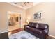 Cozy living room featuring rich hardwood floors, plush sofa, and charming decor at 10227 Windsong Rd, Punta Gorda, FL 33955