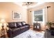 Comfortable living room with hardwood floors, leather sofa, and natural light at 10227 Windsong Rd, Punta Gorda, FL 33955