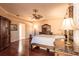 Primary bedroom boasts hardwood floors, a ceiling fan, and beautiful bedroom furnishings at 10227 Windsong Rd, Punta Gorda, FL 33955