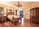 Spacious main bedroom with hardwood floors, ceiling fan, and sliding glass doors to the patio at 10227 Windsong Rd, Punta Gorda, FL 33955