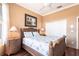 Bedroom with wicker furniture, hardwood floors, and a tropical-themed wall art at 10227 Windsong Rd, Punta Gorda, FL 33955