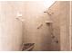 Tiled shower stall featuring marble corner seat, handheld shower head, and grab bar at 10227 Windsong Rd, Punta Gorda, FL 33955