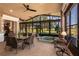 Inviting sunroom with hot tub, tile floors, large windows, and comfortable dining and seating areas at 10227 Windsong Rd, Punta Gorda, FL 33955