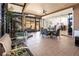 Relaxing sunroom with a hot tub, tile floors, access to outside and view into kitchen at 10227 Windsong Rd, Punta Gorda, FL 33955
