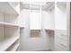 Walk-in closet with white shelving and drawers on both sides providing ample storage space at 10227 Windsong Rd, Punta Gorda, FL 33955