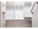 Walk-in closet with white shelving and racks, providing multiple storage options at 10227 Windsong Rd, Punta Gorda, FL 33955