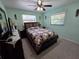 Bedroom with a patterned quilt, dark wood furniture, and view of the window at 1173 Belkton Ave, Port Charlotte, FL 33948