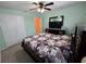 Bedroom showcasing a queen bed, ceiling fan, closet, dresser, and a glimpse of another room at 1173 Belkton Ave, Port Charlotte, FL 33948