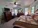 Bedroom featuring bed with quilt, dresser, and dual windows providing natural light at 1173 Belkton Ave, Port Charlotte, FL 33948