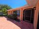 A welcoming covered front entrance with a screen door and a well-kept garden area at 1173 Belkton Ave, Port Charlotte, FL 33948