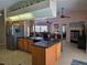 Open kitchen with granite countertops, stainless appliances, and view of the living room at 1173 Belkton Ave, Port Charlotte, FL 33948