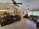 Open-concept living room with tile floors, ceiling fans, and views into the kitchen at 1173 Belkton Ave, Port Charlotte, FL 33948