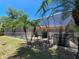 Screened-in pool area with outdoor seating offering a relaxing backyard oasis at 1173 Belkton Ave, Port Charlotte, FL 33948