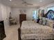 Comfortable bedroom with patterned bedding, ceiling fan, and natural light at 1233 Dewhurst St, Port Charlotte, FL 33952