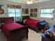bedroom with two beds, two windows and posters on the walls at 1233 Dewhurst St, Port Charlotte, FL 33952