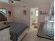Bedroom in pink with vanity, and a view into an ensuite bathroom at 1233 Dewhurst St, Port Charlotte, FL 33952