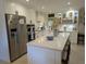 Modern kitchen with white cabinets, stainless steel appliances, and a large island at 1233 Dewhurst St, Port Charlotte, FL 33952