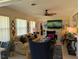 Comfortable living room with a fireplace, TV, and blue accent chairs at 1233 Dewhurst St, Port Charlotte, FL 33952