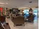 Elegant living room featuring ornate furnishings, neutral tile flooring and slider doors to the outside at 1233 Dewhurst St, Port Charlotte, FL 33952