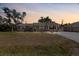 Charming single-story home featuring a well-maintained lawn and a spacious driveway at dusk at 1249 Indus Rd, Venice, FL 34293
