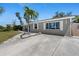 This home has a concrete driveway leading up to a charming single-story home with neutral paint at 1249 Indus, Venice, FL 34293