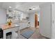 Bright kitchen featuring white cabinets, tile backsplash, modern appliances, and wood-look flooring at 1249 Indus, Venice, FL 34293