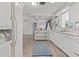 Bright kitchen featuring white cabinets, modern appliances, wood-look floors, and an open-concept design at 1249 Indus, Venice, FL 34293