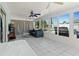 Sunroom with tile floors, ceiling fans, a comfortable couch, and views of the pool and backyard at 1249 Indus, Venice, FL 34293