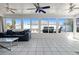 Inviting sunroom with tile floors, ceiling fans, and a clear view of the pool and fenced backyard at 1249 Indus, Venice, FL 34293