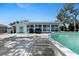 Backyard pool featuring sunroom with plentiful windows and a wood patio at 1249 Indus, Venice, FL 34293