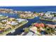Overhead capture of homes lining waterways, offering access to the bay in a beautiful coastal residential neighborhood at 125 Donna Ct, Punta Gorda, FL 33950