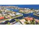 Aerial view of canal-front homes with boat docks offering direct access to the open bay in this waterfront neighborhood at 125 Donna Ct, Punta Gorda, FL 33950
