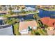 Aerial shot showcases the waterfront property with lush landscaping, and its private boat dock on the canal at 125 Donna Ct, Punta Gorda, FL 33950