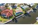 Aerial view of a charming home with a pool and a private dock on a picturesque waterfront canal at 125 Donna Ct, Punta Gorda, FL 33950