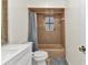 Bathroom features a modern vanity, a shower with peach colored tile, and a toilet at 125 Donna Ct, Punta Gorda, FL 33950