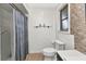 This bathroom features a shower with blue striped curtain and accent tile, plus a white toilet at 125 Donna Ct, Punta Gorda, FL 33950